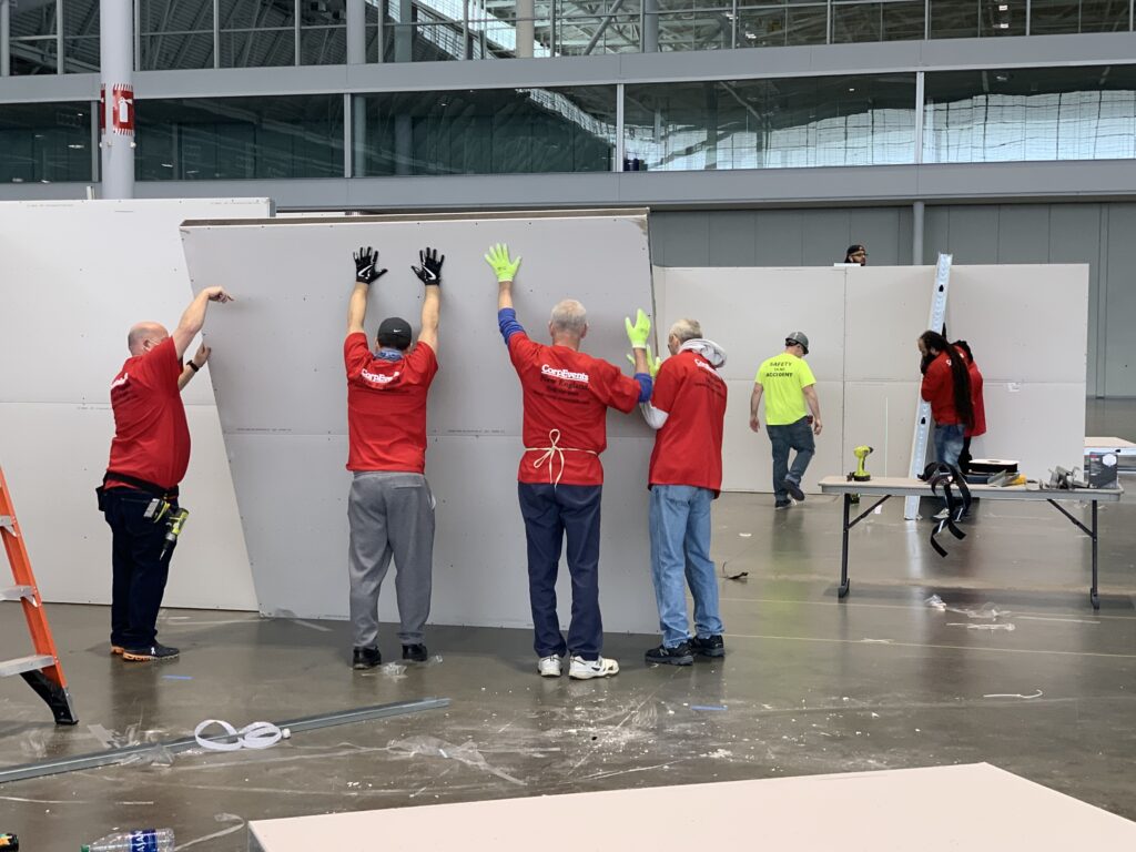 Workers put up cubicles at Boston Convention and Exposition Center