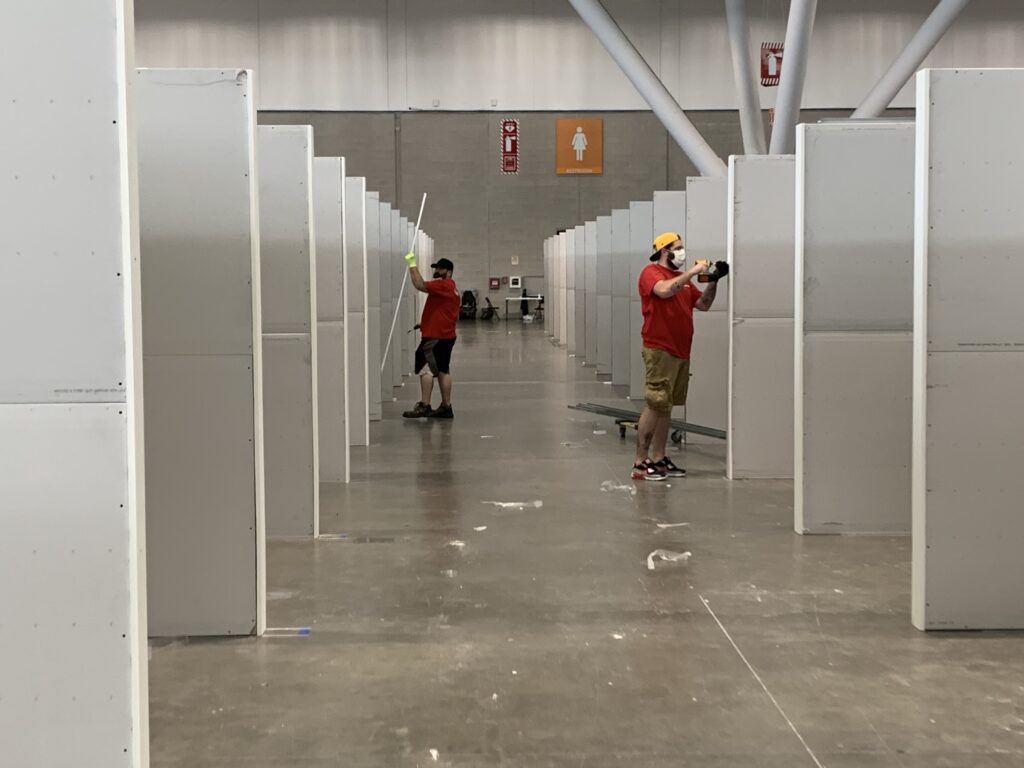Workers build cubicles at Boston Covention and Exposition Center