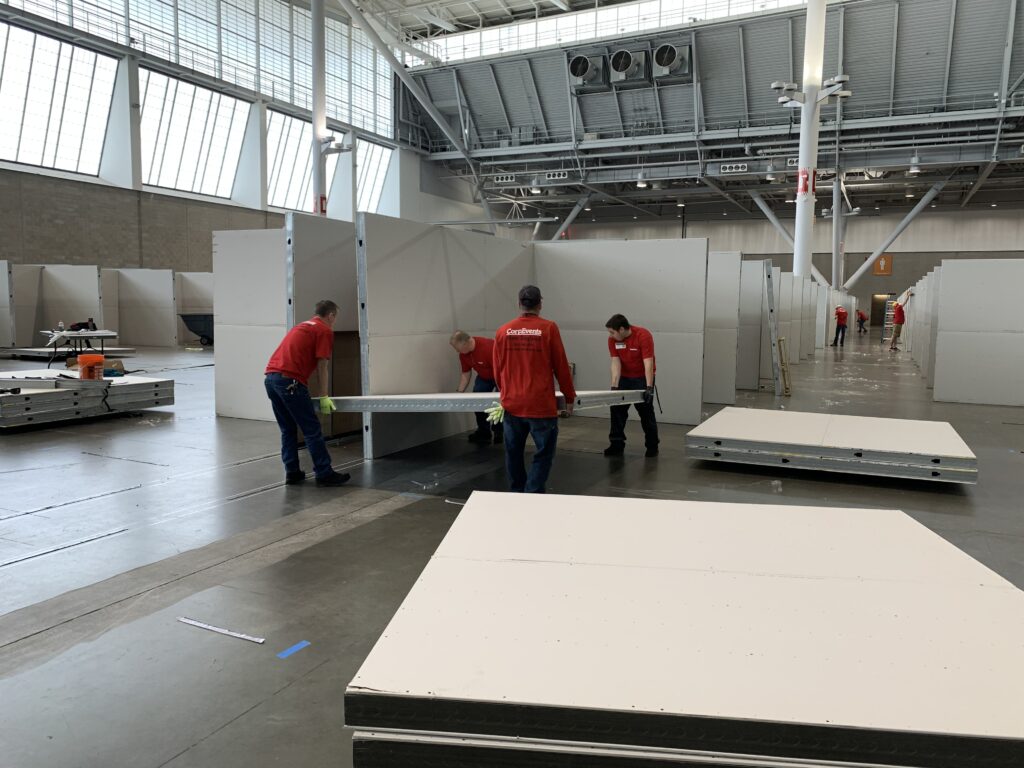 Workers build cubicles at Boston Covention and Exposition Center
