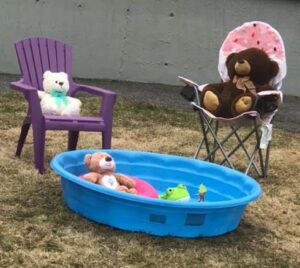 Stuffed bears around a wading pool