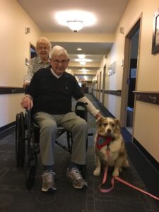 Therapy dog Raisin visits with Muriel and Bob Welge, parents of Raisin’s owner/handler, Hopkinton resident Allison Ruggeri.