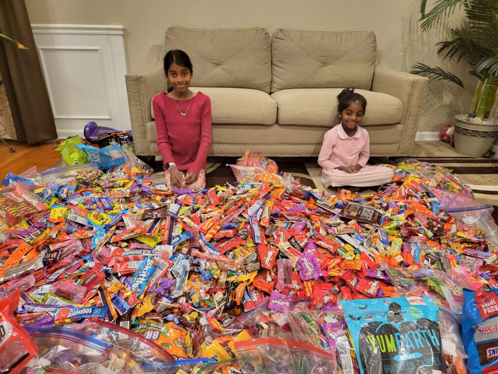 Hopkinton sisters Aadya and Rishvi Namagalla show off the candy they collected